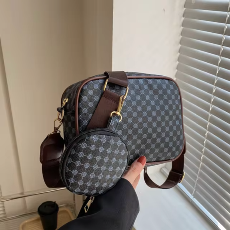 Nahkainen olkalaukku, jossa aurinkoinen geometrinen kuvio